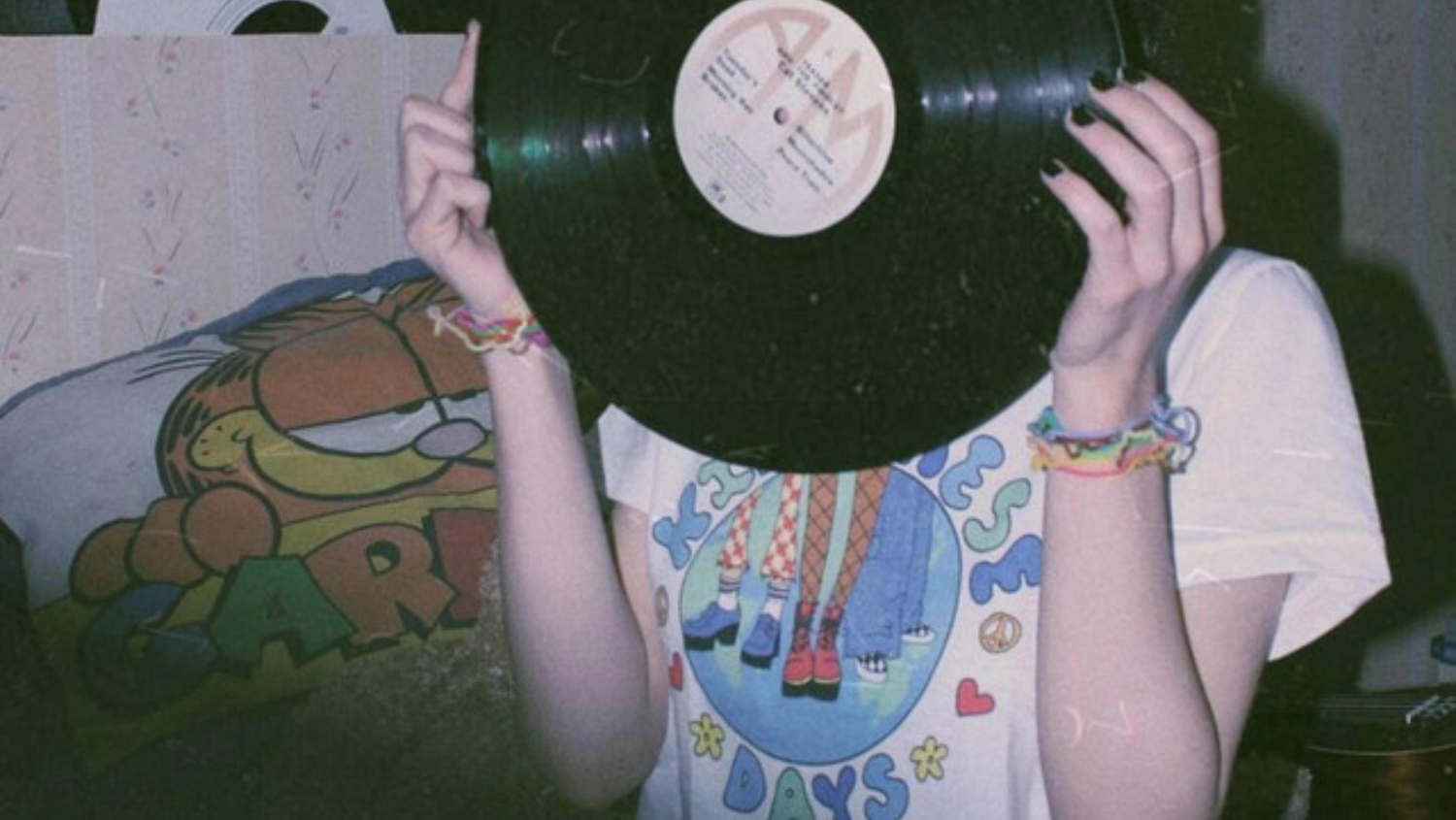 indie girl holding record with garfield in the background